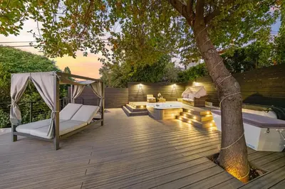 a deck with a hammock and a tree at Farley Court in Los Angeles