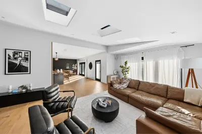 a living room with a brown couch and chairs at Farley Court in Los Angeles