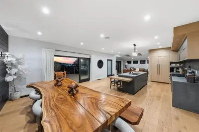 a kitchen and living room with a large wooden table at Farley Court in Los Angeles