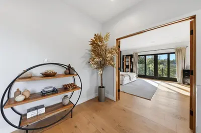 a living room with a potted plant and a mirror at Farley Court in Los Angeles