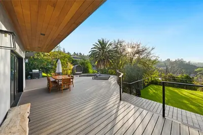 a wooden deck with a table and chairs on it at Farley Court in Los Angeles