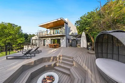 a deck with a fire pit and a house at Farley Court in Los Angeles