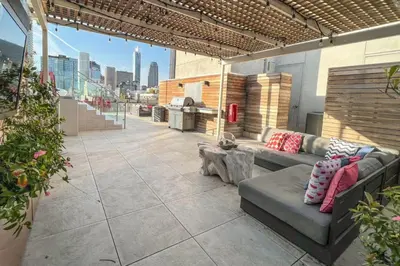 a patio with a couch and a table on a building at Blueground Historic Core view nr Grand Park LAX-1424 in Los Angeles