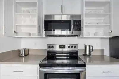 a kitchen with a stove and a microwave at Blueground Melrose pool nr Griffith Park LAX-1399 in Los Angeles