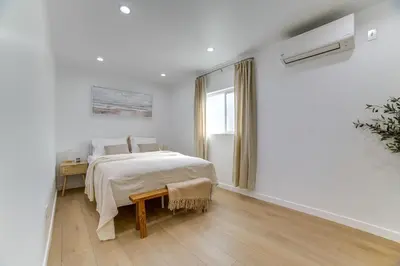 a white bedroom with a bed and a window at Work and Play! Apt Less Than 1 Mi to Chino Valley Hospital in Chino