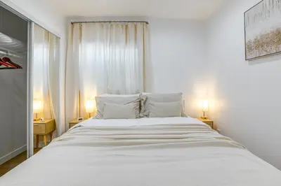 a bedroom with a large white bed with two lamps at Work and Play! Apt Less Than 1 Mi to Chino Valley Hospital in Chino