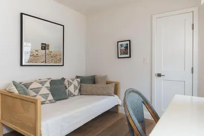 a living room with a couch and a table at Naples Island Stunning Ocean Cottage By the Beach in Long Beach