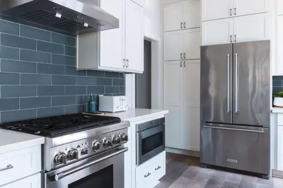 a kitchen with a stove and a refrigerator at Naples Island Stunning Ocean Cottage By the Beach in Long Beach