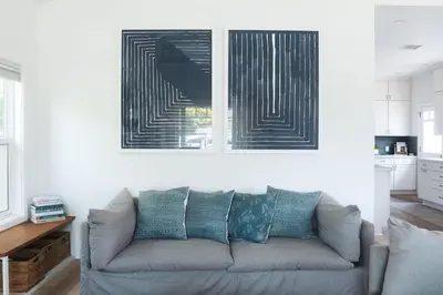 a living room with a couch and a picture on the wall at Naples Island Stunning Ocean Cottage By the Beach in Long Beach