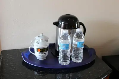 a tea kettle and two bottles of water on a tray at Garvey Inn Hotel - \u5c0f\u53f0\u5317\u9152\u5e97, Monterey Park in Monterey Park