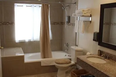 a bathroom with a toilet and a tub and a sink at Garvey Inn Hotel - \u5c0f\u53f0\u5317\u9152\u5e97, Monterey Park in Monterey Park