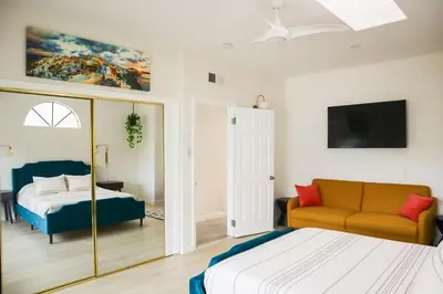 a bedroom with a bed and a couch at Beauty And The Beach in Ventura