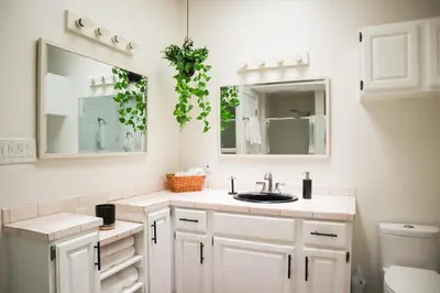 a white bathroom with a sink and mirrors at Beauty And The Beach in Ventura