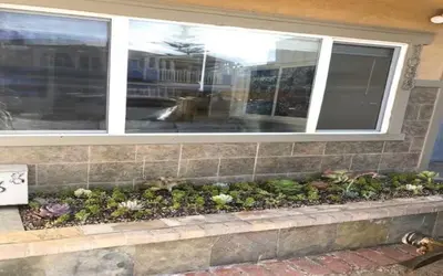 a window ledge with plants in front of a house at Beauty And The Beach in Ventura