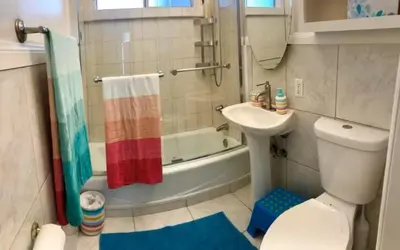 a bathroom with a toilet and a sink and a shower at Beauty And The Beach in Ventura