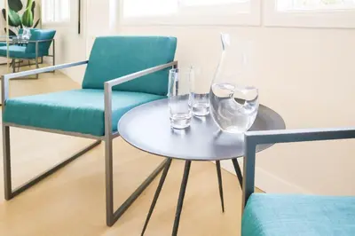 a table with two chairs and glasses on it at Beauty And The Beach in Ventura