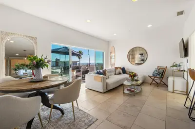 a living room with a table and a couch at Ocean View condo in the heart of Manhattan Beach in Manhattan Beach