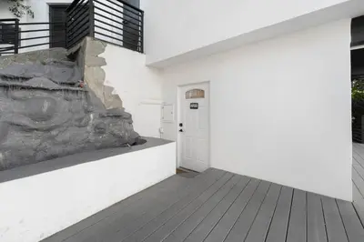 a hallway of a white building with a door at Hollywood Hills Retreat - Next to Universal Studios in Los Angeles