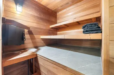 a sauna with wooden walls and a tv and towels at Hollywood Hills Retreat - Next to Universal Studios in Los Angeles