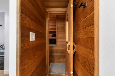 a wooden door leading into a room with wood paneling at Hollywood Hills Retreat - Next to Universal Studios in Los Angeles