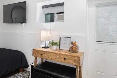 a bedroom with a table with a lamp and a bed at Hollywood Hills Retreat - Next to Universal Studios in Los Angeles