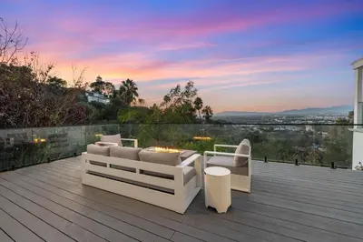 a deck with two white couches and a fire pit at Hollywood Hills Retreat - Next to Universal Studios in Los Angeles