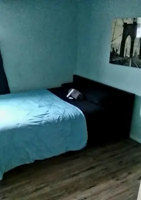 a bedroom with a bed and a wooden floor at The Vibe in Los Angeles