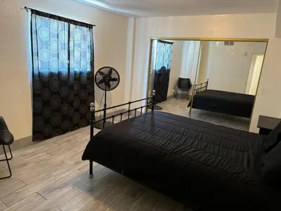 a bedroom with a bed and a mirror at The Vibe in Los Angeles