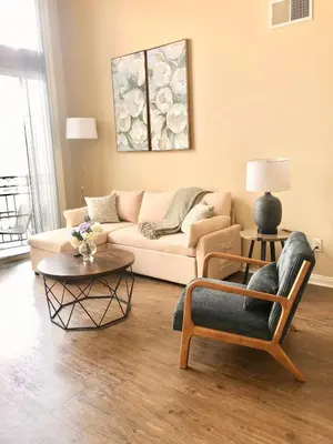 a living room with a couch and a table at Spacious 2B 2B Pool View Loft Apartment in Marina Del Rey in Los Angeles