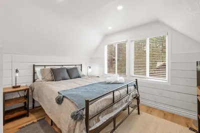 a bedroom with a large bed and a window at Navigate Stays 5BR Group Lodge Near Mountain & Fun in Big Bear Lake