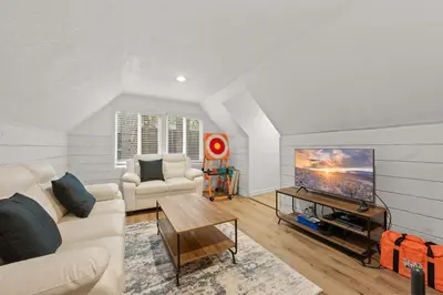 a living room with a couch and a tv at Navigate Stays 5BR Group Lodge Near Mountain & Fun in Big Bear Lake