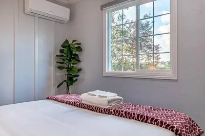 a bedroom with a bed with a red and white blanket at Cozy Comfort LA House with Stunning Scenic Views in Monterey Park