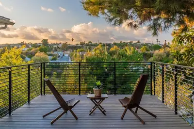 two chairs and a table on a deck with a view at Cozy Comfort LA House with Stunning Scenic Views in Monterey Park