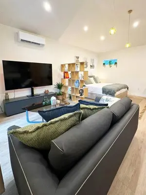 a living room with a couch and a large television at Chic Studio Haven by Century City - FH2 - BV in Los Angeles