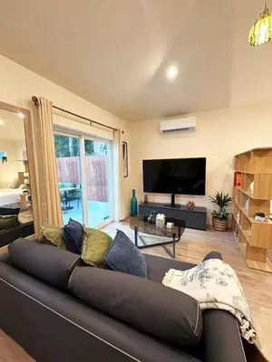 a living room with a couch and a flat screen tv at Chic Studio Haven by Century City - FH2 - BV in Los Angeles