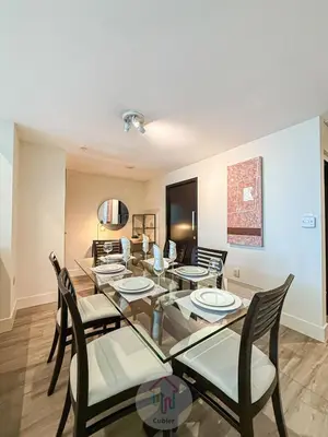 a dining room with a glass table and chairs at Sleek 1BR Loft in Luxury High-Rise - 103 - GL in Glendale