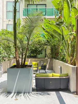 a group of chairs and plants in a courtyard at Sleek 1BR Loft in Luxury High-Rise - 103 - GL in Glendale