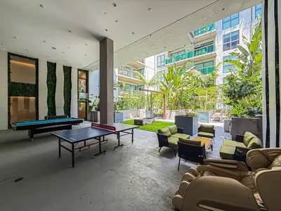 a living room with a pool table and chairs at Sleek 1BR Loft in Luxury High-Rise - 103 - GL in Glendale