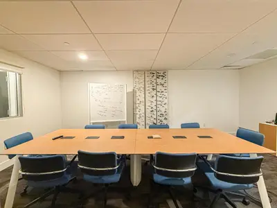 a conference room with a large wooden table and chairs at Sleek 1BR Loft in Luxury High-Rise - 103 - GL in Glendale