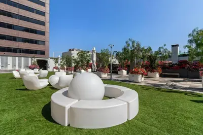 a park with white chairs on the grass at Modern 2BR Loft with Luxury Amenities - 109 - GL in Glendale
