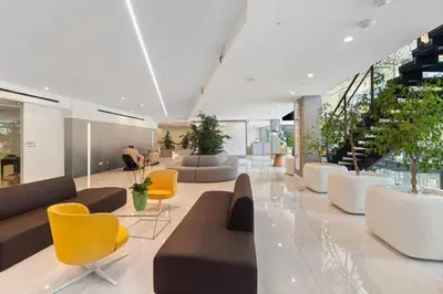 a lobby with couches and chairs and plants at Modern 2BR Loft with Luxury Amenities - 109 - GL in Glendale