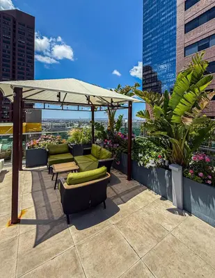 a patio with chairs and an umbrella on a building at Modern 2BR Loft with Luxury Amenities - 109 - GL in Glendale