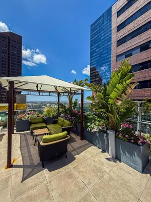 a patio with chairs and an umbrella on a building at Luxury Loft Living 1BR in Trendy Complex -113-GL in Glendale