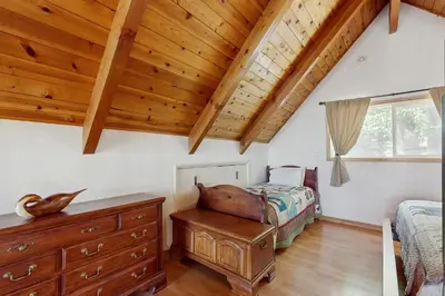a bedroom with a bed and a wooden ceiling at Cedar Glen Hideaway in Lake Arrowhead