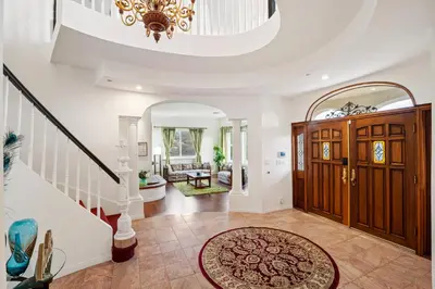 a large foyer with a staircase and a large entry door at Mountain View Luxury Estate with Pool in West Hills in Chatsworth Lake Manor