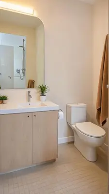 a bathroom with a toilet and a sink and a mirror at Chic Residences Steps from Beverly Hills & Sony Pictures in Los Angeles