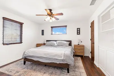 a bedroom with a bed and a ceiling fan at Silverstrand Beach House in Oxnard
