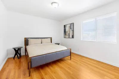 a bedroom with a bed in a white room at Spacious Culver City 4BR - Half Block from Amazon in Los Angeles