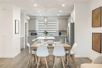 a kitchen and dining room with a table and chairs at Modern Townhouse Near Disneyland & OC Beaches in Covina