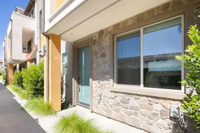 a building with a window and a stone wall at Modern Townhouse Near Disneyland & OC Beaches in Covina